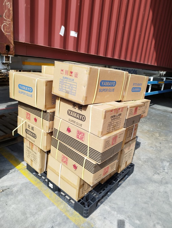 Many stationery boxes tied together and placed on a pallet for Last Mile Delivery