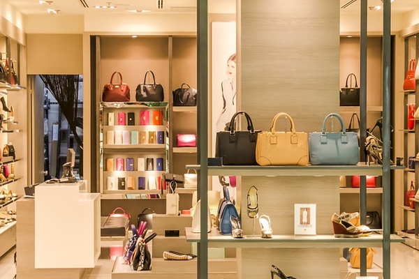 A retail setup showcasing a variety of bags and footwear in different size